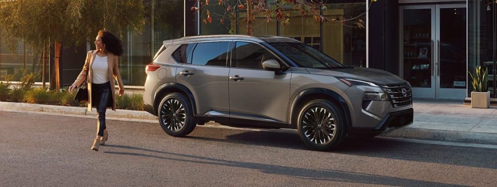 2026 Nissan Rogue parked on a city street with a person walking.