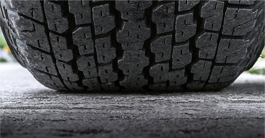 Close-up view of a vehicle tire tread showing its condition and tread depth.